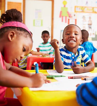 Preschool class , boy looking to camera